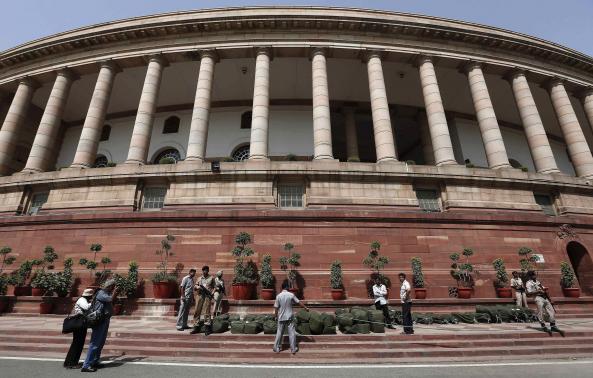 Indian security personnel stand guard near sacks containing the papers of the budget for the 2014-15 fiscal year, at the parliament in New Delhi July 10, 2014. REUTERS-Adnan Abidi-Files