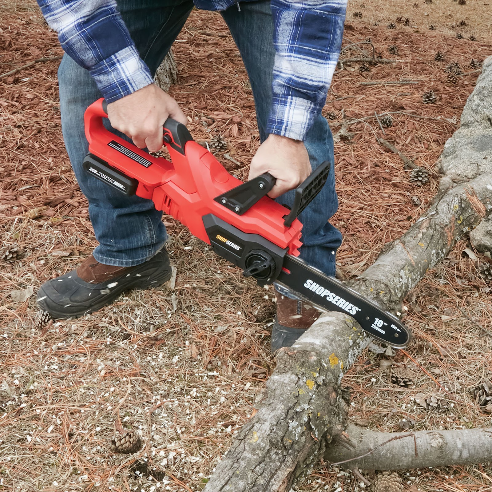 Red chain saw cutting through wood