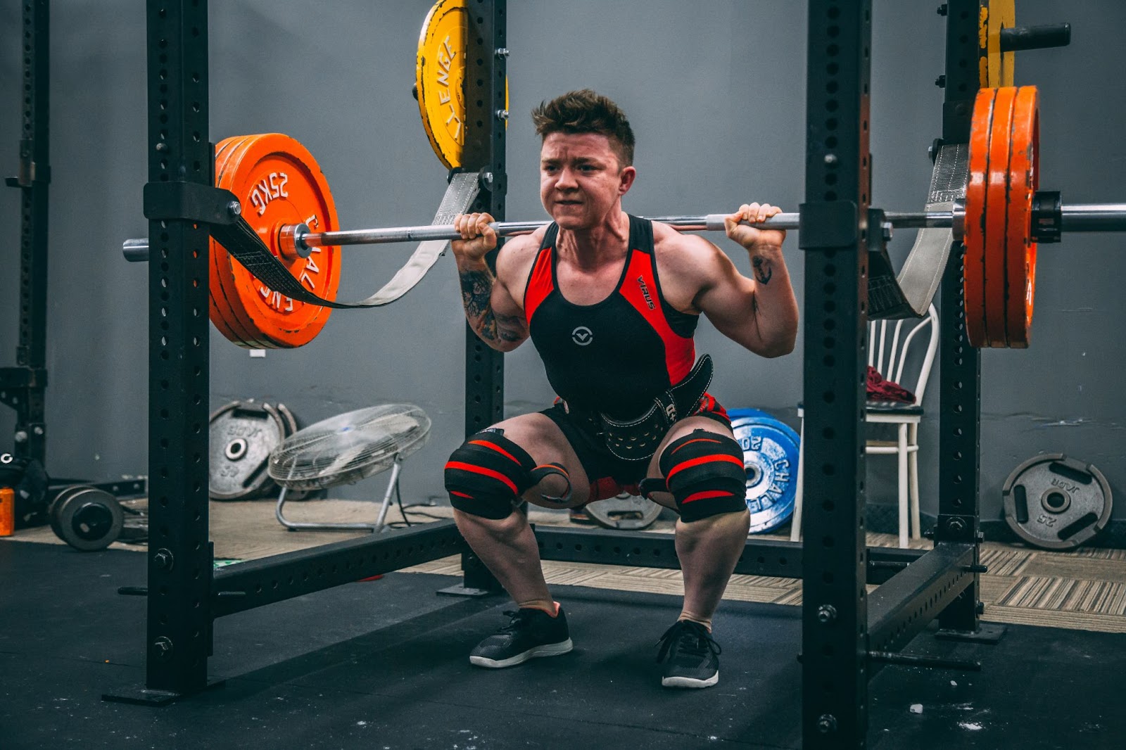 Man Squatting With Barbell