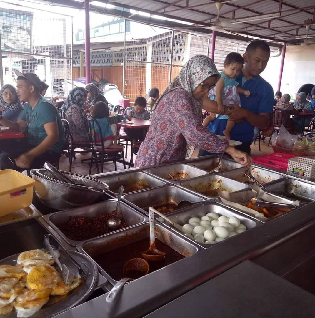 A group of people preparing food in a kitchen

Description automatically generated