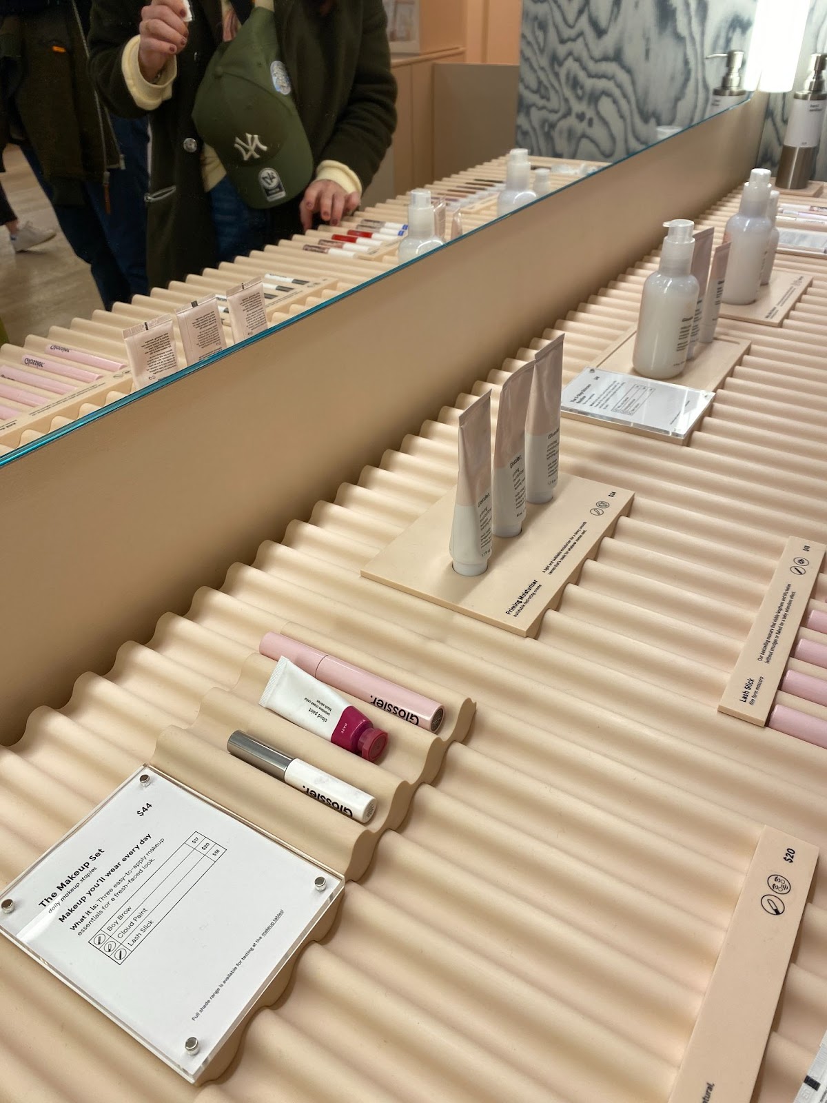 An image of Glossier's same product bundle in a physical retail location.