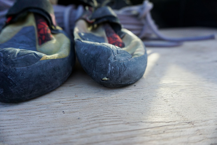 Climbing shoes worn down through the rand and toe cap