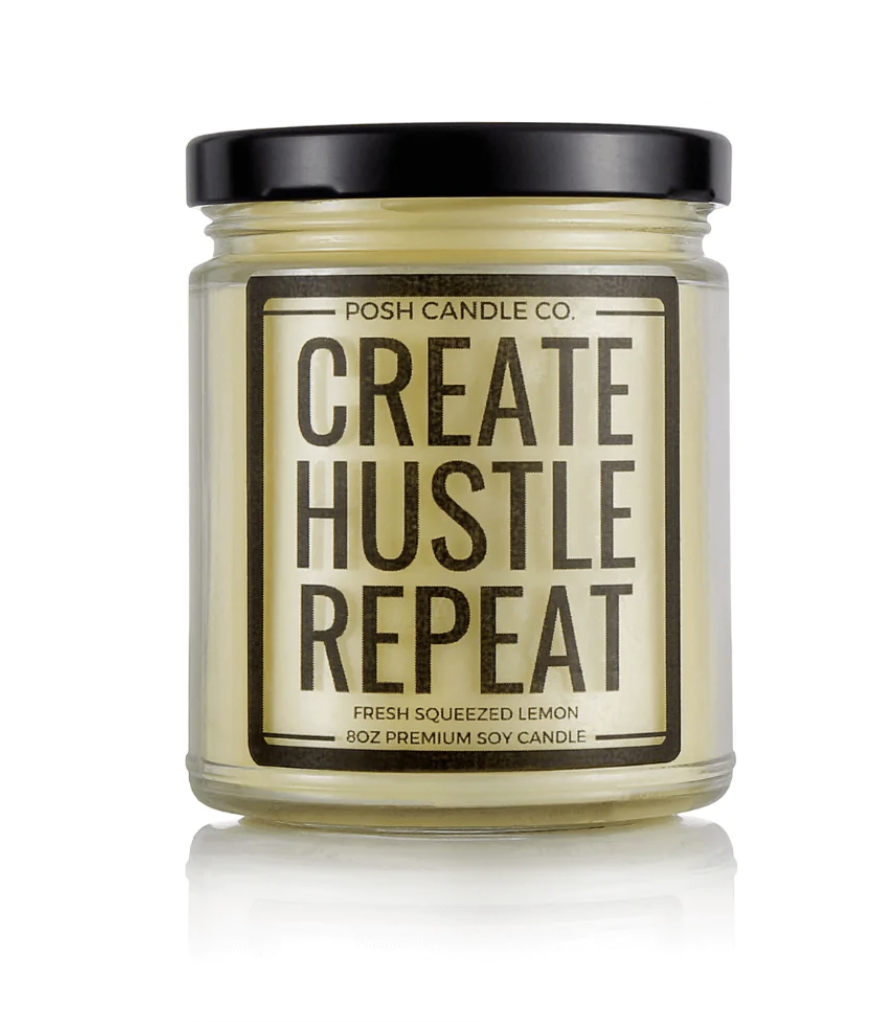 photo of a yellow candle that says "create hustle repeat" scented fresh squeezed lemon from Posh Candle Co