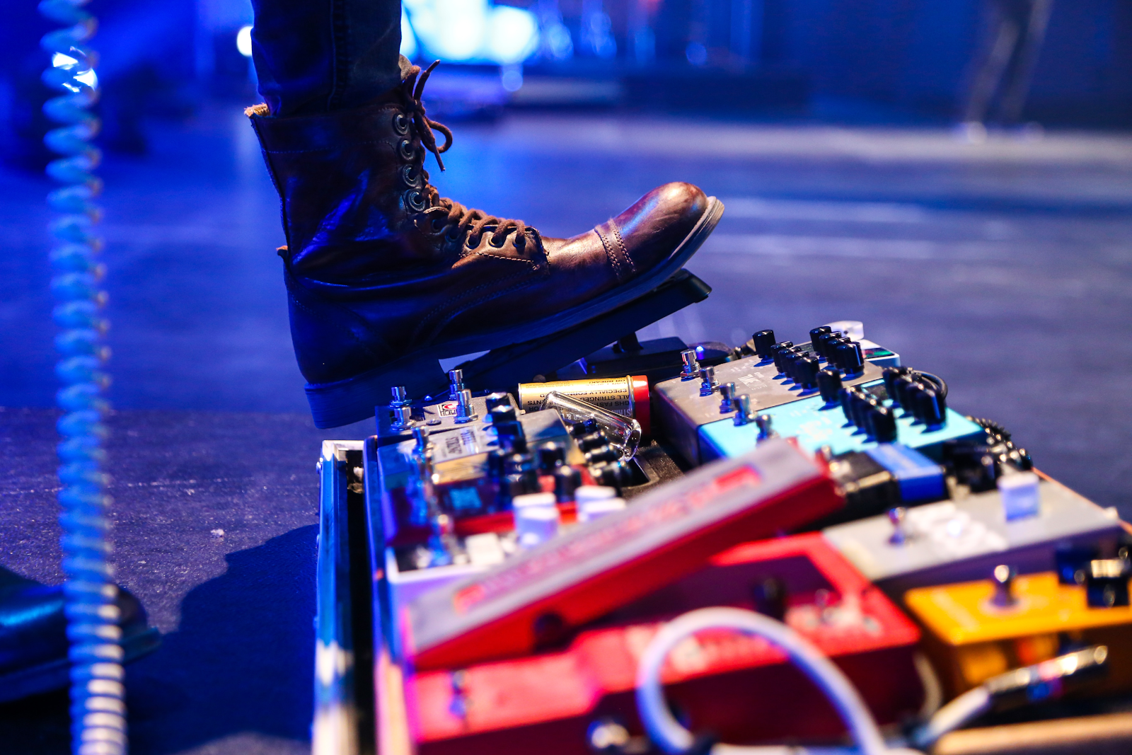A pedal board fitted with many different guitar pedals.
