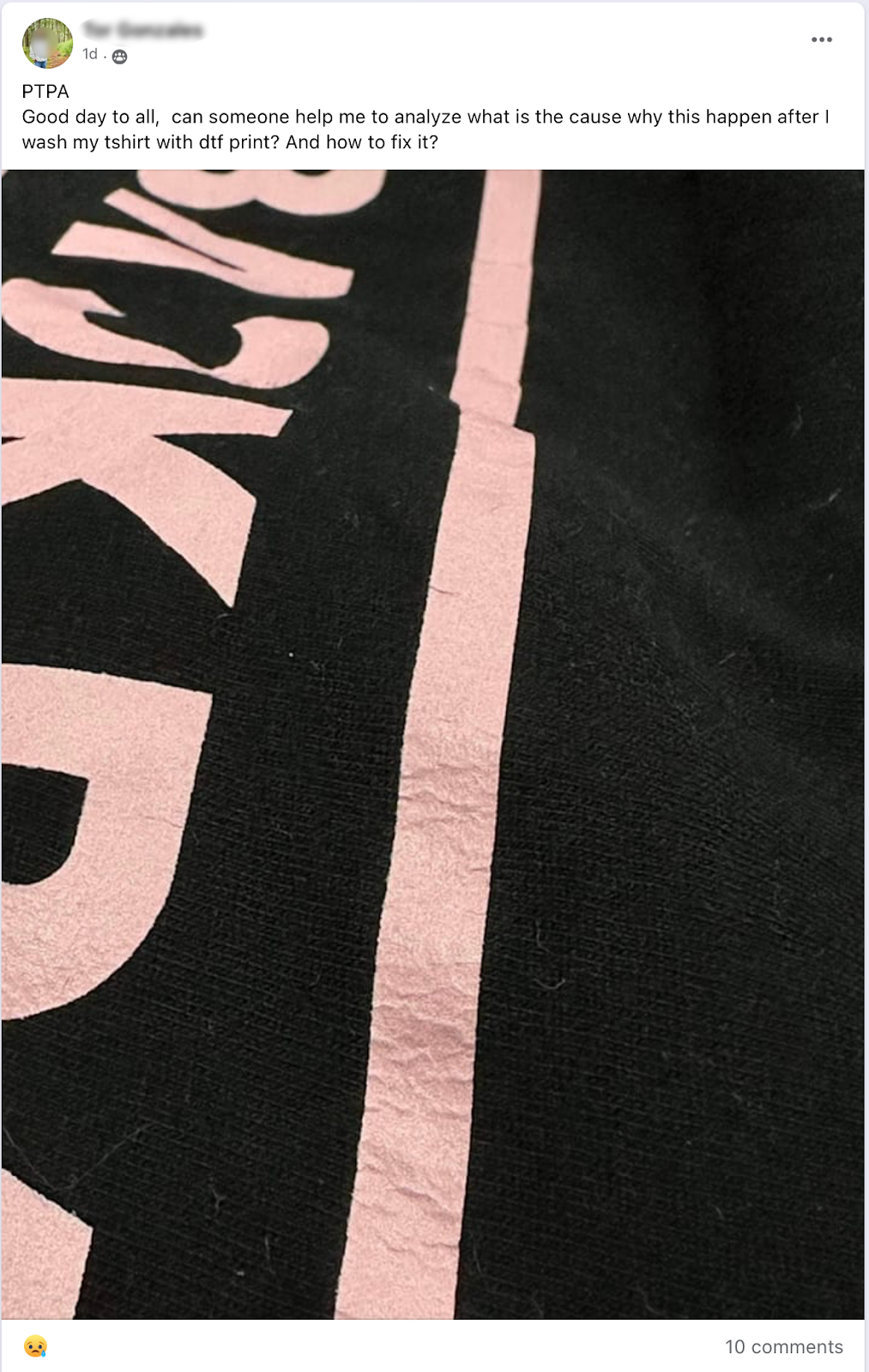 A black t-shirt with light pink DTF (Direct-to-Film) print