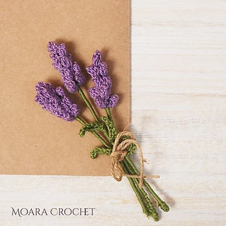 bouquet of three lavender flowers on wooden background