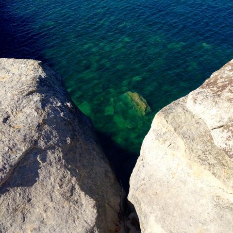 Looking down into the green and blue waters of Pictured Rocks. 