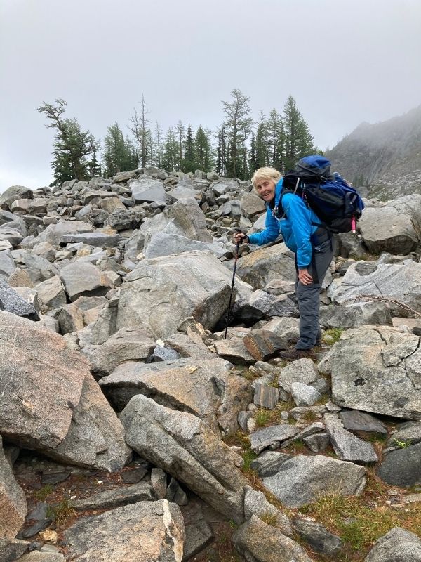 Susan Yates, with backpack, hiking up toward Lake Edna