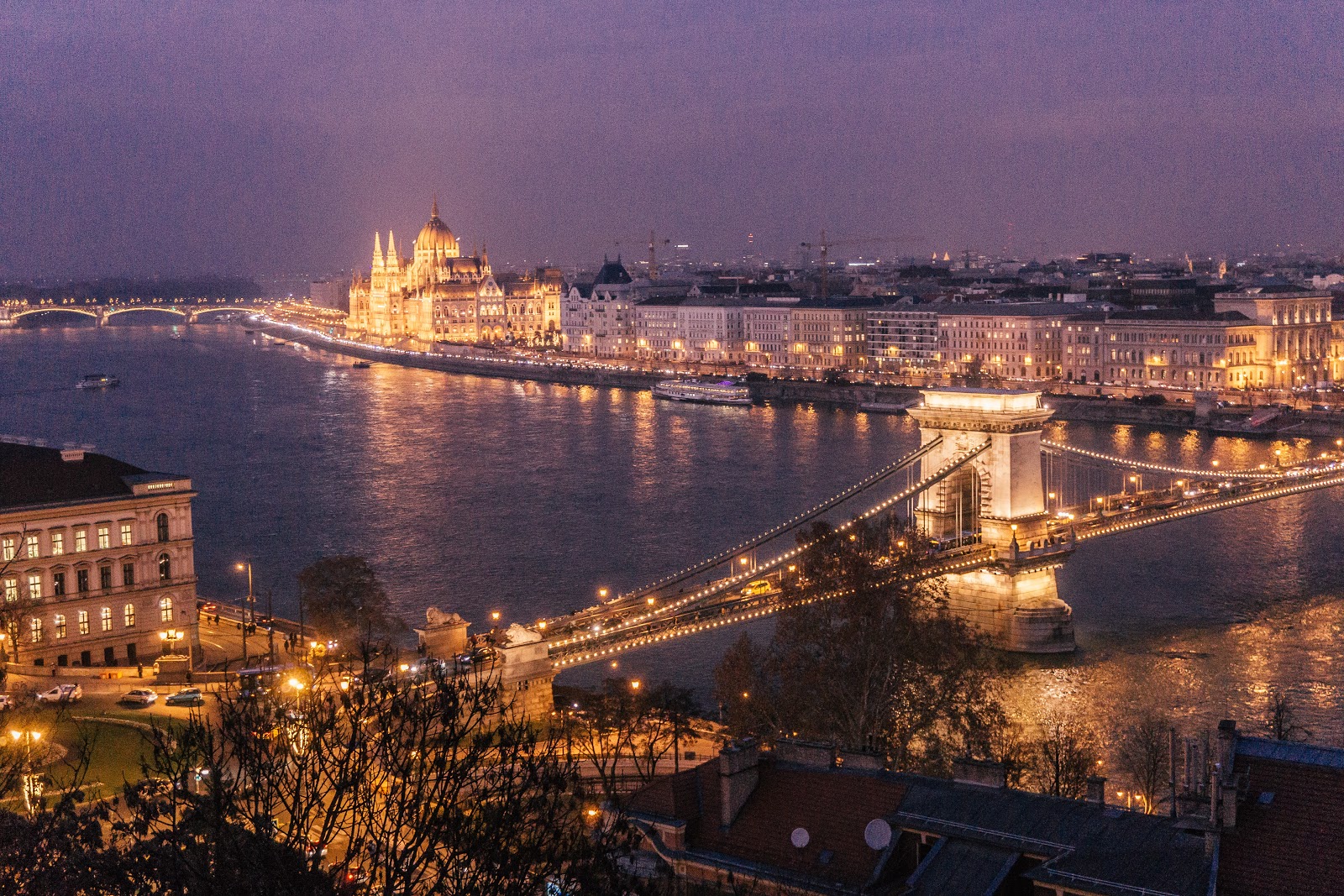 Best places for digital nomads: Budapest, Hungary parliament building and bridges all lit up at dusk.