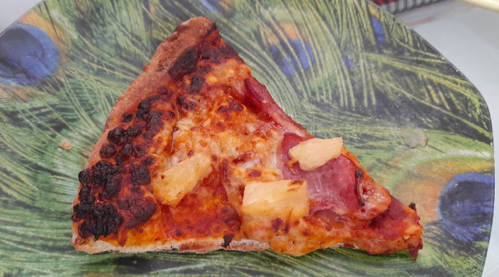 Slightly burned Hawaiian pizza.