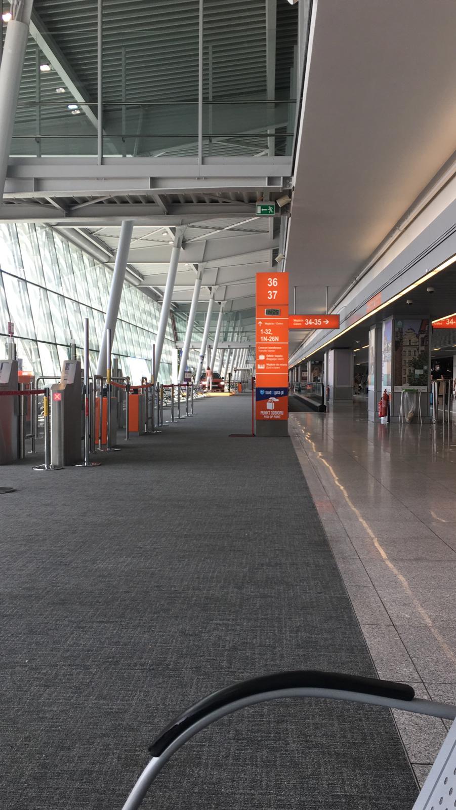 warsaw chopin airport interior, gate 36 is completely empty during the coronavirus pandemic. Flights resumed, no people in terminal building.