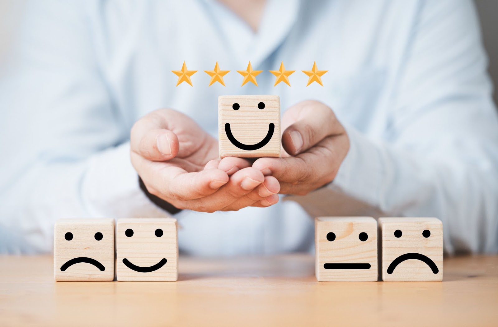 holding-smile-face-wooden-cube-block-with-other-face-emotion-excellent-evaluation-customer-satisfaction