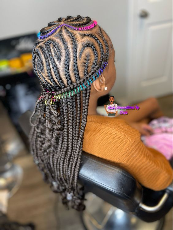 Kiddies Braid Hairstyles: Full view of a young girl  showing off her multi colored braids