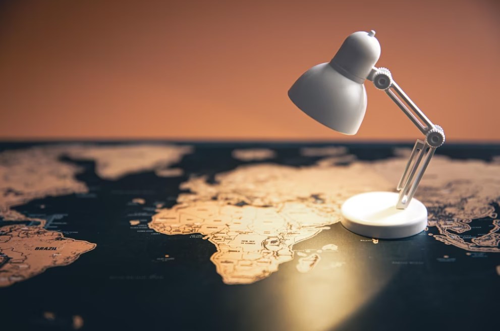 a small table lamp standing on the world map