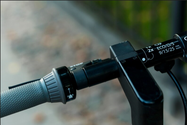 A close up of a camera attached to a bike handle.