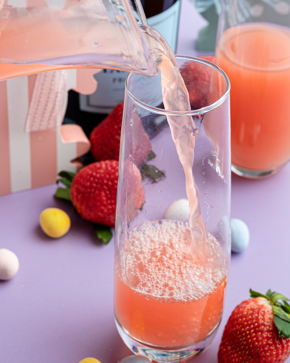 strawberry peach juice poured on a champagne flute
