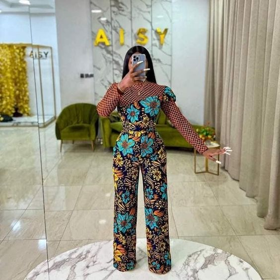 lady taking mirror selfie wearing mixed print ankara jumpsuit