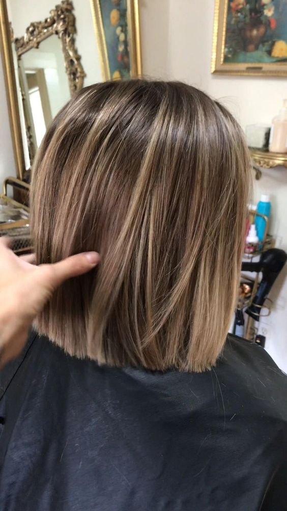 Woman wearing blunt cut hair with highlights