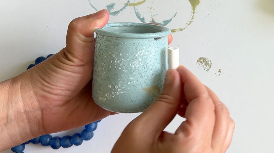 rubbing chalk on the painted jar