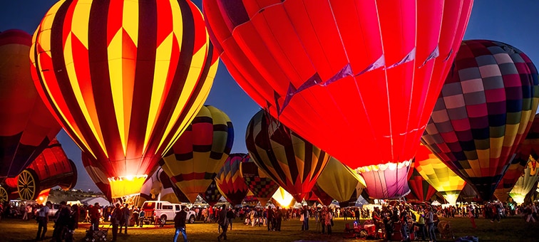 Low light image of colourful hot air balloons