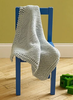 small diagonal loom knit blanket on chair