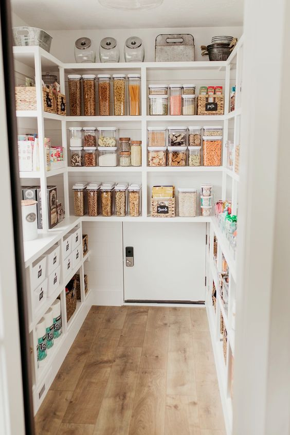 large walk in white pantry design with matching glass jars and containers