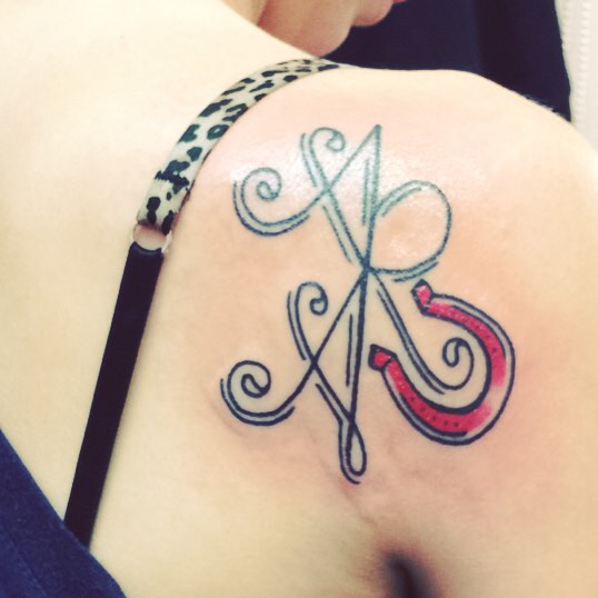 Sibling Name Tattoo On Back Shoulder