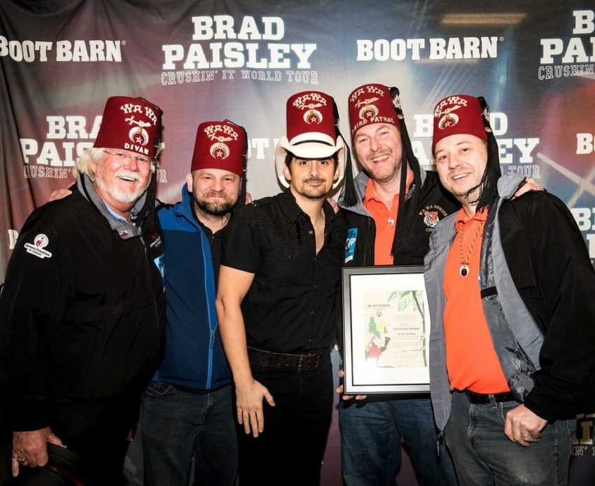 Brad Paisley posing in fez with Shriners