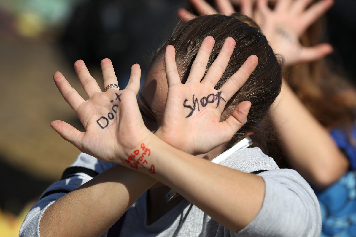 A student takes part in a protest against gun violence at Marjory Stoneman Douglas High School on March 14th, 2018, in Parkland, Florida.