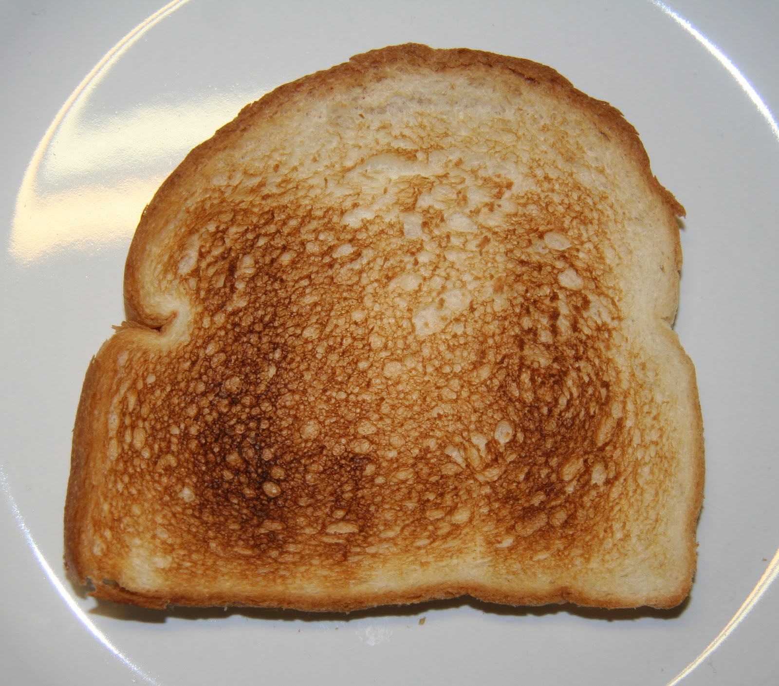 A plain dry slice of toast on