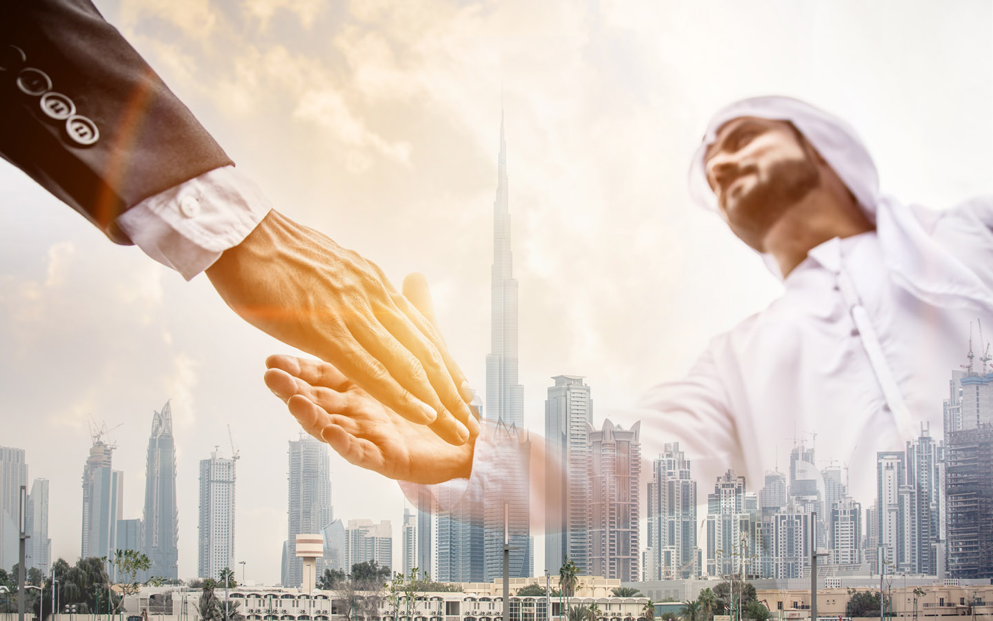 two businessman shaking hands with dubai buildings in background