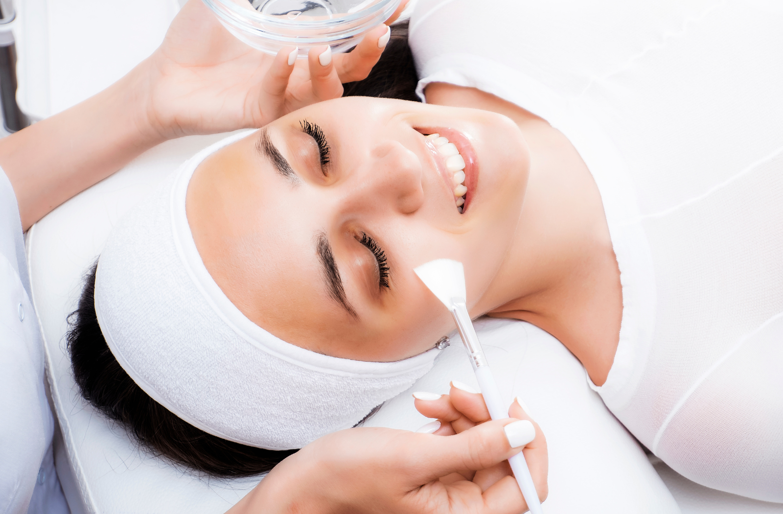 A woman receiving a chemical peel treatment on her face