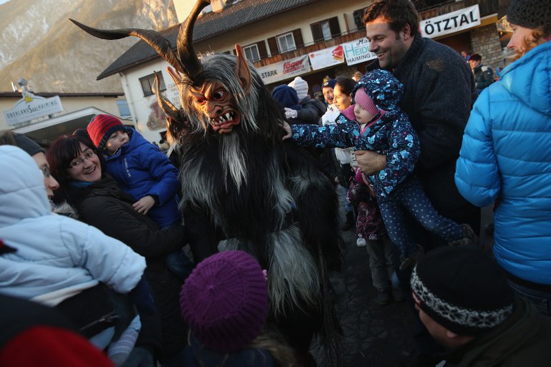 A member of the Haiminger Krampusgruppe dressed as the Krampus creature, an Austrian winter solstice ritual, lets himself be touched by onlookers prior to the annual Krampus night in Tyrol on Dec. 1, 2013.