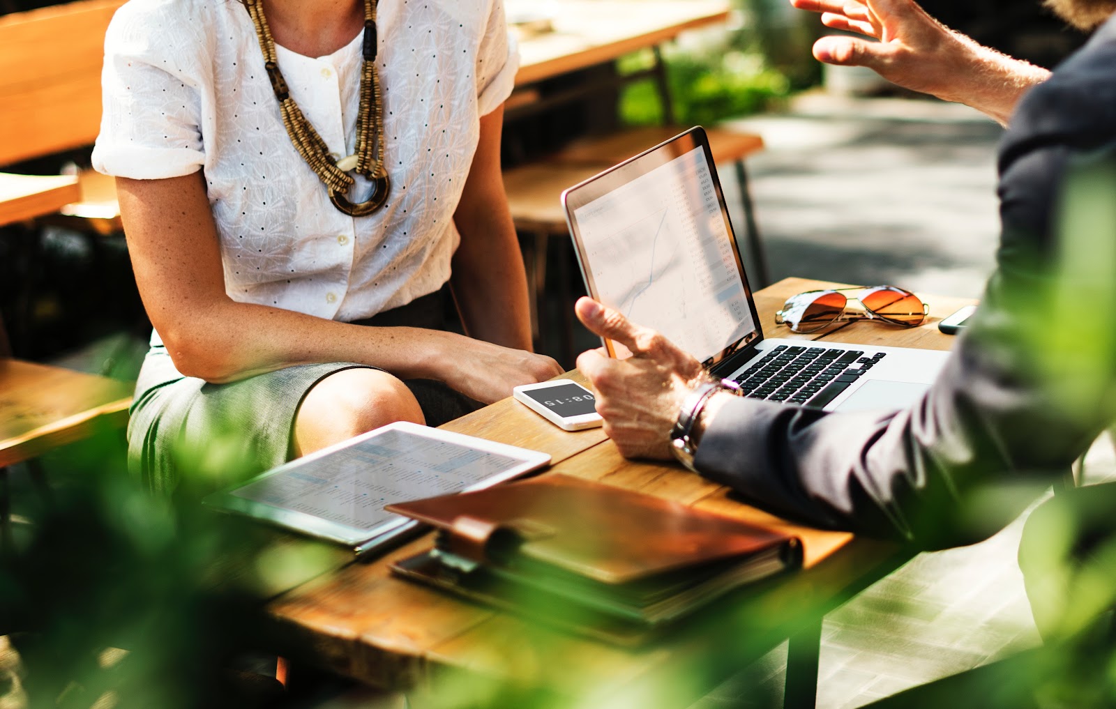 two people sitting down with an open computer finding ways to focus on business