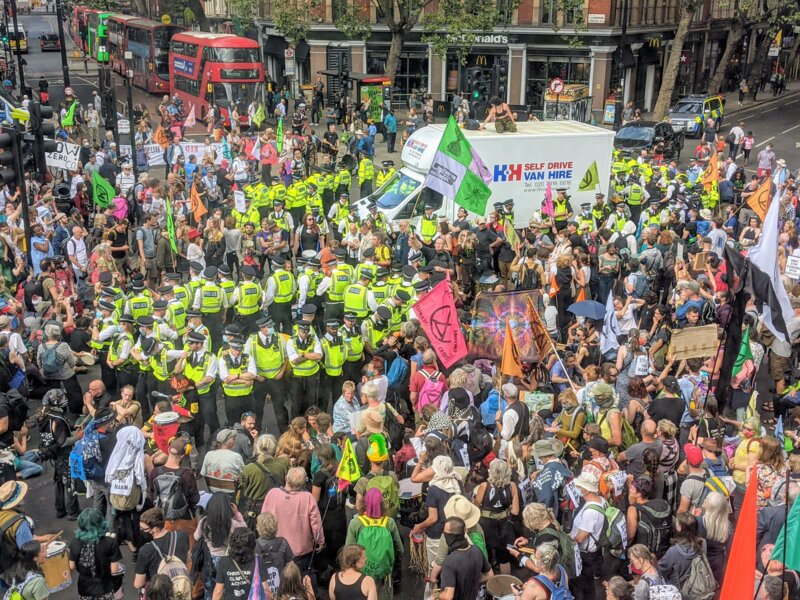 The crowd in Cambridge Circus, encircling the police officers