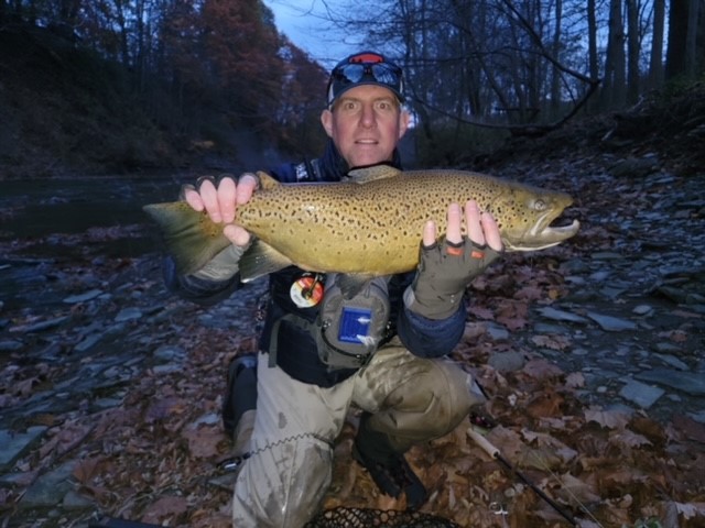 Chris at dusk on the bank with a big Brown Trout