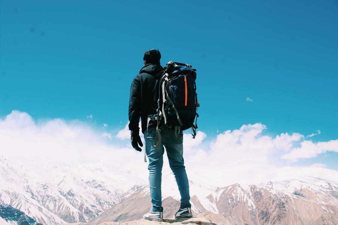 Free Photo of Man Standing On Top Of Mountain Stock Photo