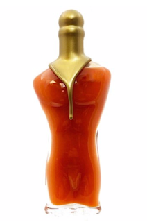 A glass bottle of hot sauce in the shape of a man's body
