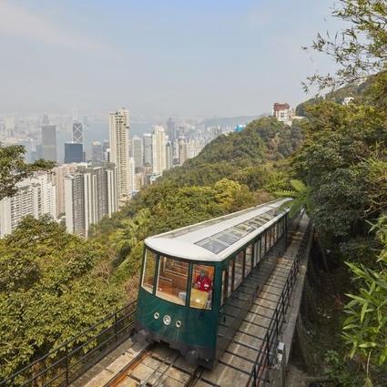 A train on a track with trees and buildings in the background

Description automatically generated with low confidence