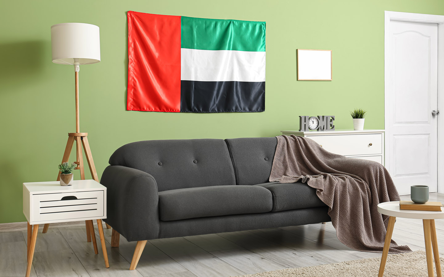 UAE flag placed behind sofa in living room to add up to national day home decor
