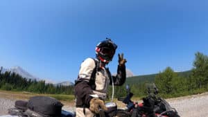Rider throwing up the peace sign before hitting the road