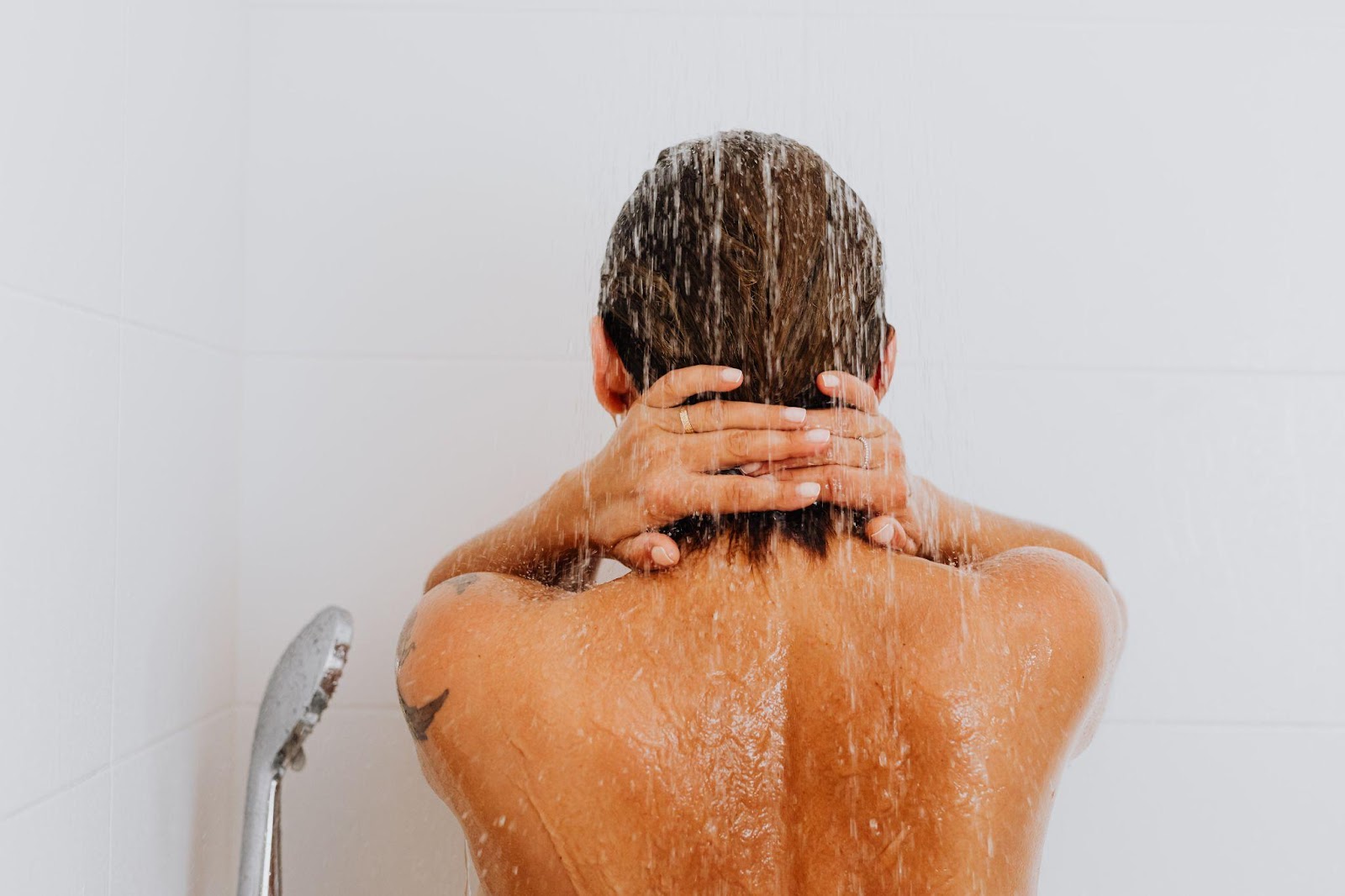 Rear view of a person taking a long shower