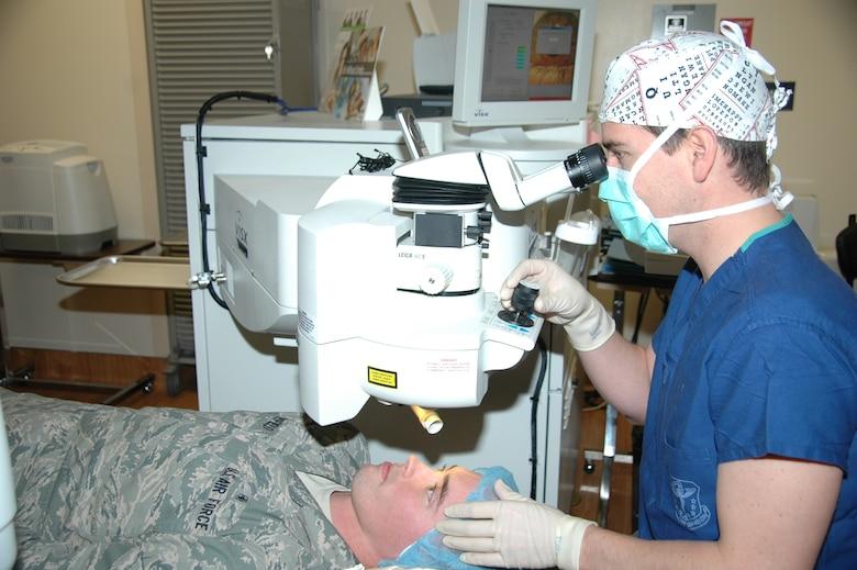 Dr. Christopher Kurz, a cornea and refractive surgeon, demonstrates the capabilities of the refractive surgery VISX Star S4 laser on Airman Matthew Mansfield in the new Ophthalmology Clinic and Laser Refractive Surgery Center at David Grant USAF Medical Center. (U.S. Air Force photo/James Spellman)