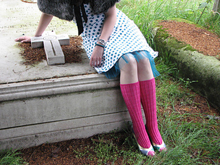 woman wearing dark pink knee high socks with heels and a dress