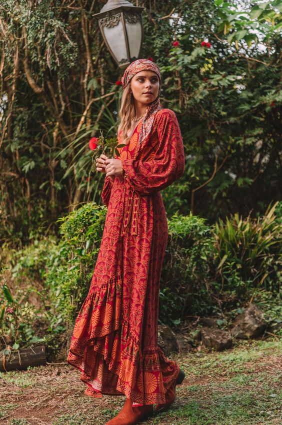 Woman holding flowers and wearing bohemian dress