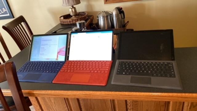 A group of laptops sit on a table

Description automatically generated with medium confidence