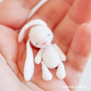 tiny amigurumi bunny held in hand