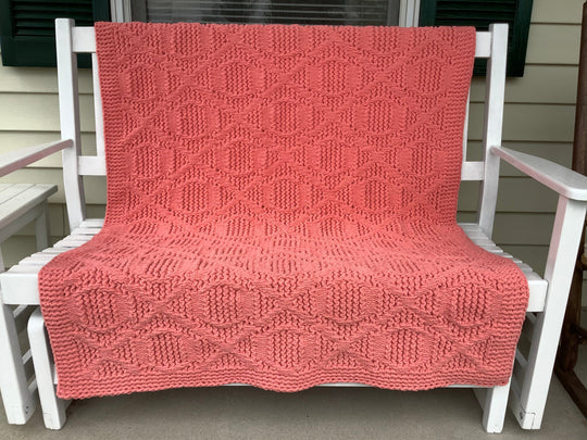 textured loom knit blanket on porch bench