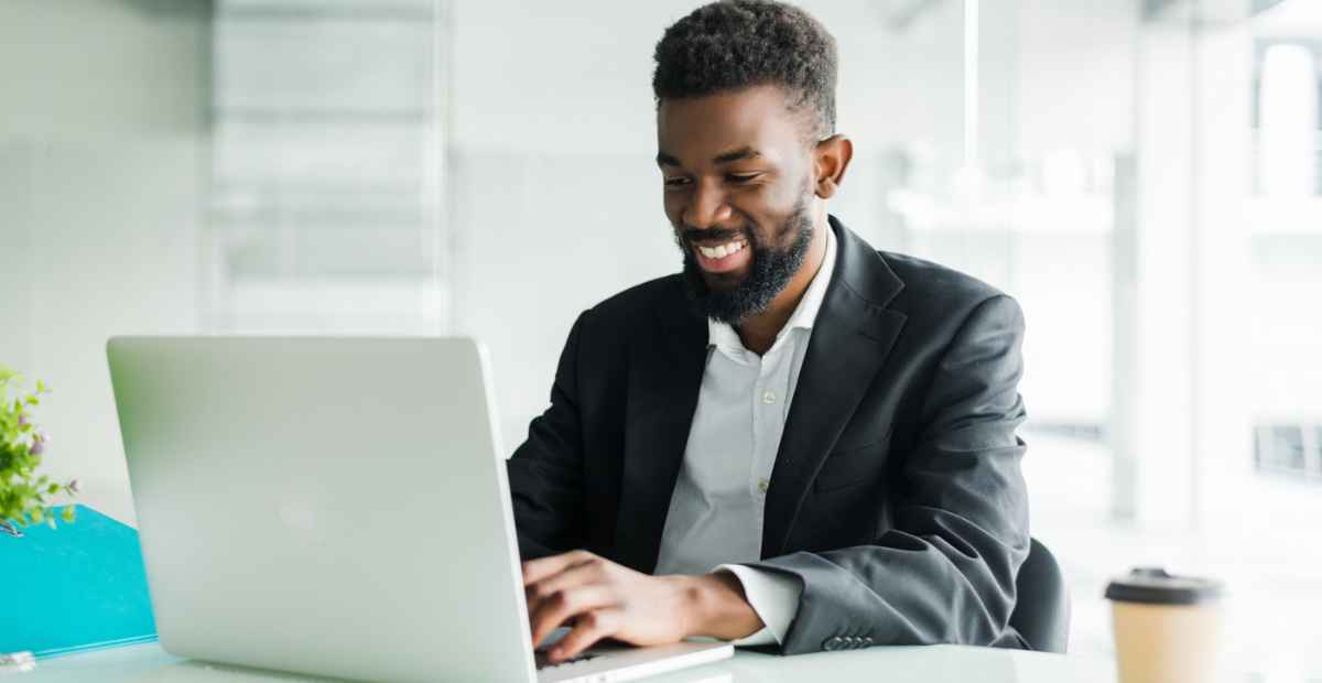 A man enabling SaaS security on his computer and smiling
