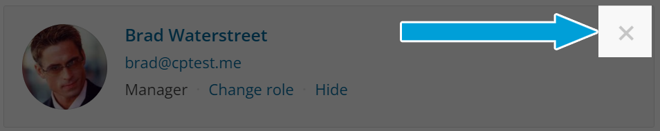 Screenshot of the information for a user as it would appear in an organization team list. It has the user profile picture in a circle on the left side (stock image that kind of looks like Brad Pitt. So we named him Brad).
To the right of the image it reads:
Brad Waterstreet
brad@cptest.me 
Manager   Change Role (clickable)   Hide (clickable)

The 'x' button is highlighted on the upper right corner with an arrow pointing to it.